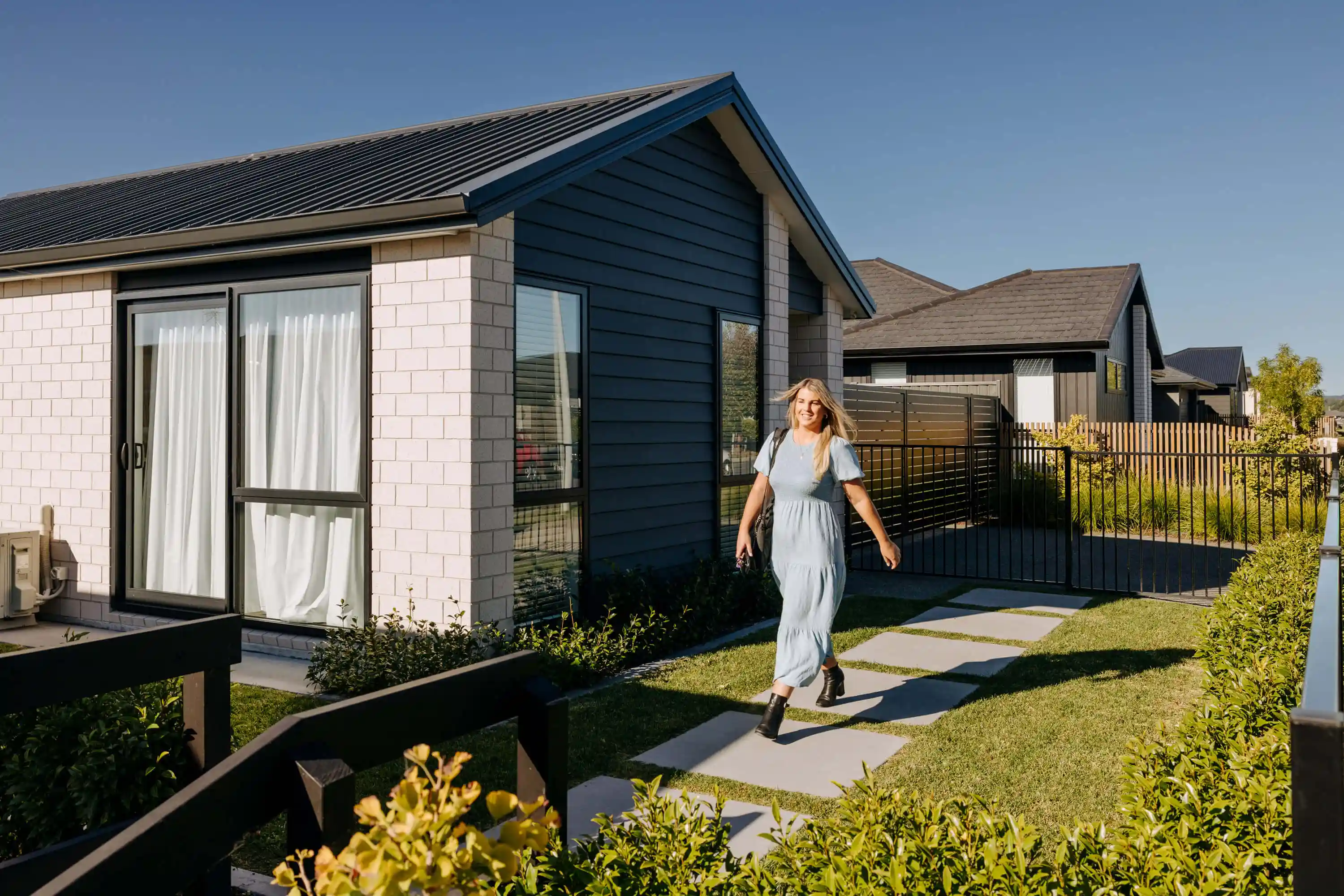 Woman walks from new house